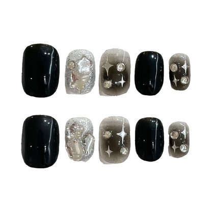 Black Ombre Star Rhinestones press-on nail set, 10 nail tips on a white background